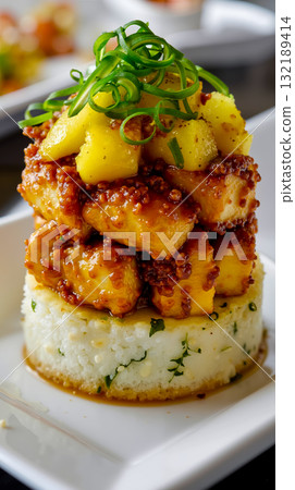 A white plate topped with rice covered in pineapple and sauce 132189414