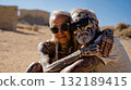 A man and a woman with tattoos on their arms in the desert 132189415