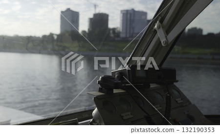 Ship captain communicating on radio in wheelhouse. Clip 132190353