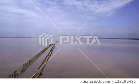 Drone flying backwards over a pink salt lake. Media 132190456