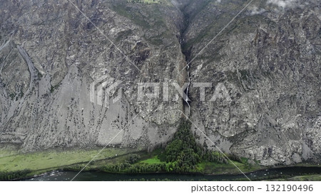 Waterfall cascading into valley between mountains in altai republic. Media 132190496