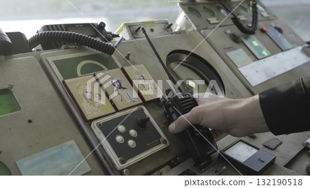 Ship captain communicating on radio in the wheelhouse. Clip 132190518