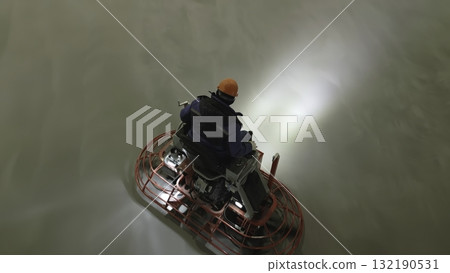 Construction worker operating a ride on power trowel machine. Clip 132190531