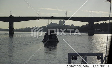Tugboat sailing under a city bridge. Clip 132190581