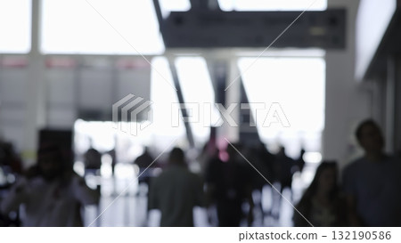 Tourists walking in busy airport terminal. Media 132190586