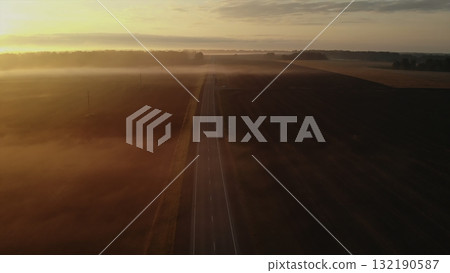 Aerial view of foggy rural road at sunrise. Media Aerial view of foggy rural road at sunrise. Media 132190587