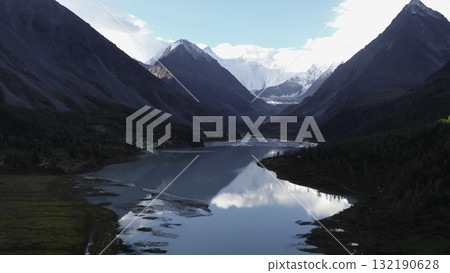 Majestic mountain lake reflecting clouds and peaks. Media Majestic mountain lake reflecting clouds and peaks. Media 132190628