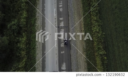 Motorcycle rider traveling on a countryside asphalt road aerial view. Clip Motorcycle rider traveling on a countryside asphalt road aerial view. Clip 132190632