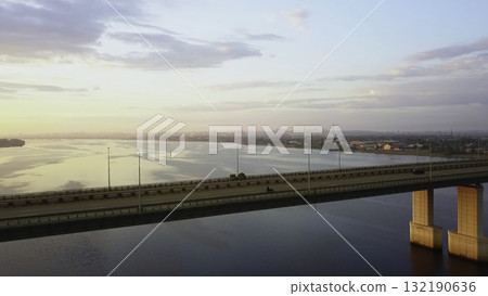 Aerial view of vehicles driving on bridge over river at sunset. Clip Aerial view of vehicles driving on bridge over river at sunset. Clip 132190636