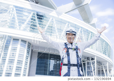 Worker wearing a full harness Worker wearing a full harness 132190894