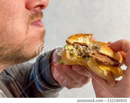 Man Eating Burger Close-Up Man Eating Burger Close-Up 132190920