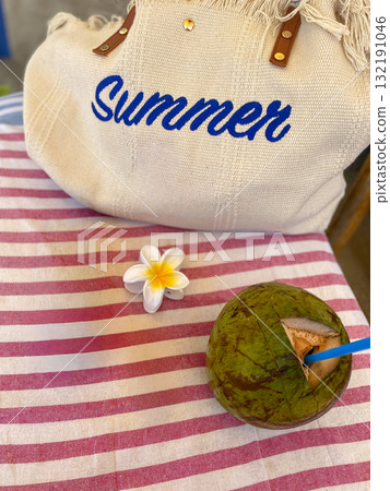 Summer Bag and Fresh Coconut Drink on Striped Tablecloth Summer Bag and Fresh Coconut Drink on Striped Tablecloth 132191046