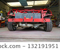 A car being disassembled for full body painting. An open sports car being prepared for full painting. 132191951