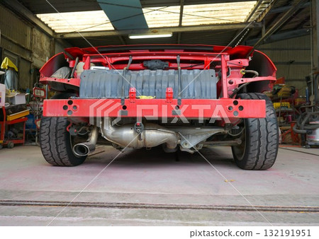 A car being disassembled for full body painting. An open sports car being prepared for full painting. 132191951