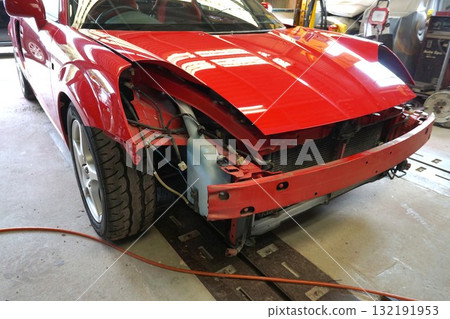 A car being disassembled for full body painting. An open sports car being prepared for full painting. A car being disassembled for full body painting. An open sports car being prepared for full painting. 132191953