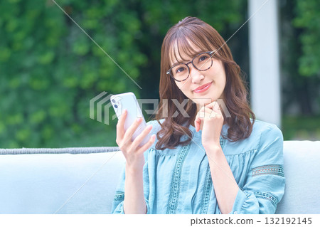 A woman watching a smartphone 132192145