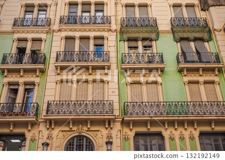 Art Nouveau building facade with wrought iron balconies and decorative stucco details in Alicante, Spain 132192149