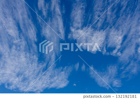 Cirrus clouds spreading across the autumn blue sky 132192181