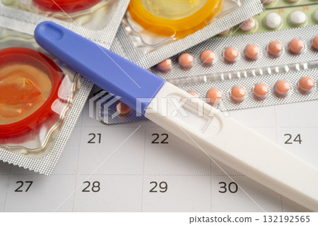 Pregnancy test and birth control pills on calendar, contraception health and medicine. 132192565