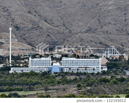 A Scenic View of a Hotel Elegantly Surrounded by Majestic Mountains and Lush Nature A Scenic View of a Hotel Elegantly Surrounded by Majestic Mountains and Lush Nature 132193012
