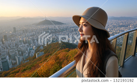 Young Woman Enjoying Scenic Sunset View of Seoul City from Elevated Observation Deck 132193192