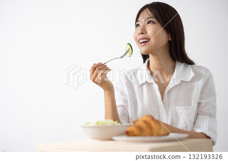 Young woman enjoying a healthy breakfast Young woman enjoying a healthy breakfast 132193326