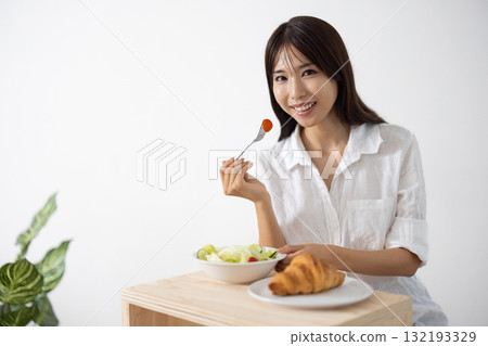 Young woman enjoying a healthy breakfast Young woman enjoying a healthy breakfast 132193329