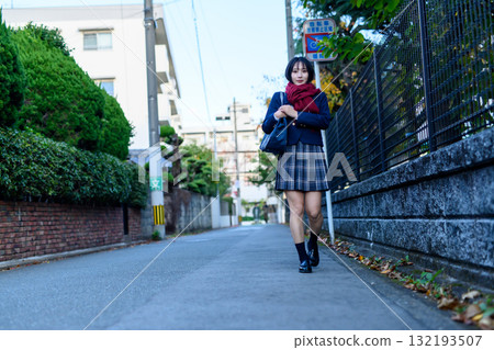 High school girls walking to and from school on a dark road on a cold day. High school girls' skirts, club activities, supplementary classes, going to and from school. 132193507