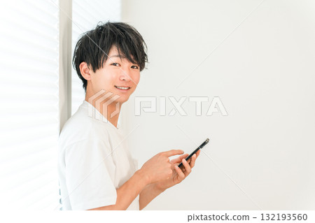 Young Asian man using smartphone (smartphone work, app, side job) Young Asian man using smartphone (smartphone work, app, side job) 132193560
