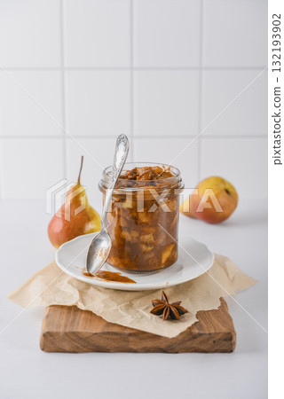 Pear jam in a glass jar with ripe pears 132193902