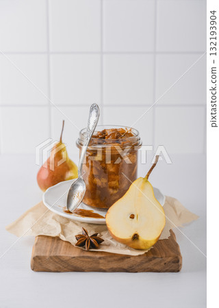 Pear jam in a glass jar with ripe pears Pear jam in a glass jar with ripe pears 132193904