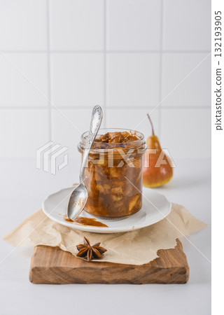 Pear jam in a glass jar with ripe pears Pear jam in a glass jar with ripe pears 132193905