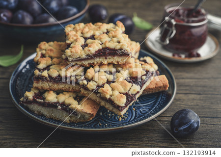 Traditional German Zwetschgenkuchen on blue plate Traditional German Zwetschgenkuchen on blue plate 132193914