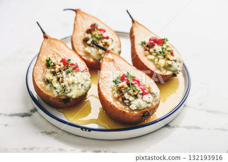 Delicious baked pears with nuts, blue cheese, thyme, cranberry and honey 132193916