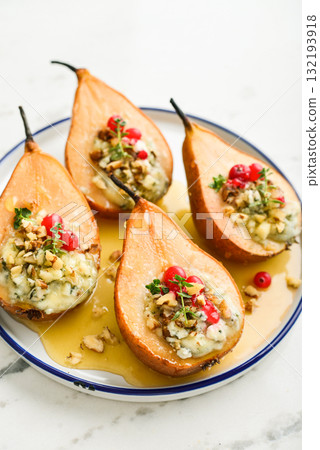 Delicious baked pears with nuts, blue cheese, thyme, cranberry and honey 132193918