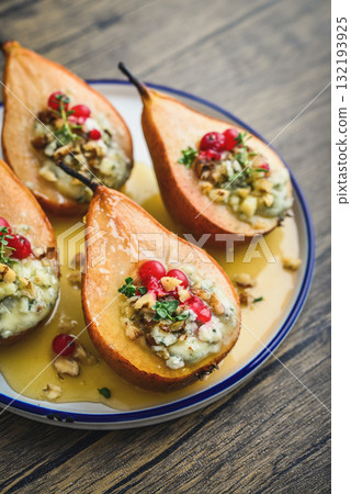 Delicious baked pears with nuts, blue cheese, thyme, cranberry and honey 132193925