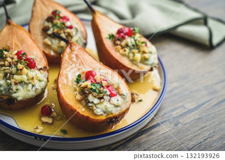Delicious baked pears with nuts, blue cheese, thyme, cranberry and honey 132193926