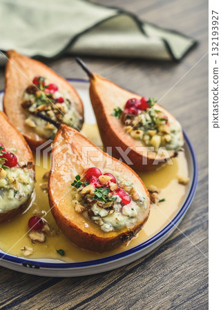 Delicious baked pears with nuts, blue cheese, thyme, cranberry and honey 132193927