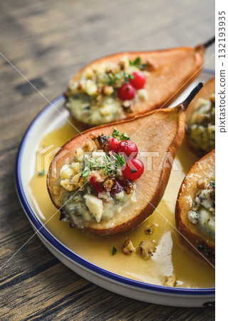 Delicious baked pears with nuts, blue cheese, thyme, cranberry and honey 132193935