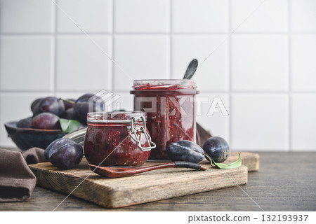 Plum jam in glass jars with ripe plums 132193937
