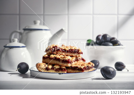 Traditional German Zwetschgenkuchen on white plate Traditional German Zwetschgenkuchen on white plate 132193947