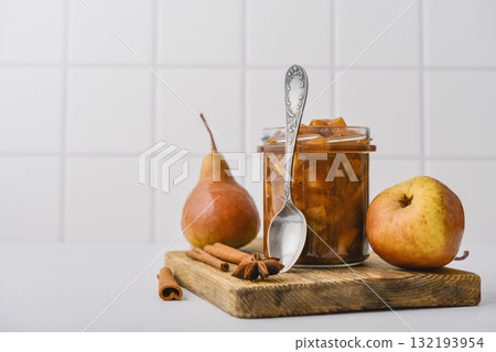 Pear jam in a glass jar with ripe pears 132193954