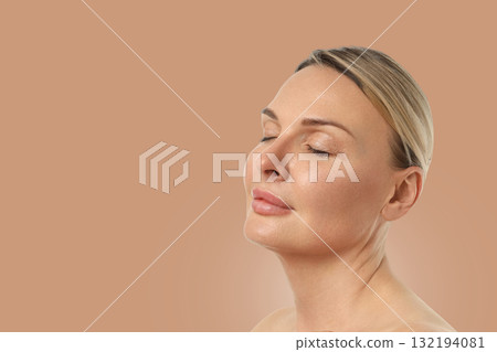 Relaxation is expressed through her gentle smile and calm demeanor 132194081