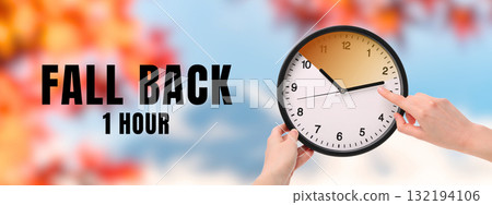 Hand adjusting clock to fall back one hour in autumn Hand adjusting clock to fall back one hour in autumn 132194106