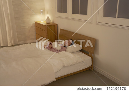 Woman sleeping in bedroom Woman sleeping in bedroom 132194178