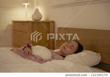 Woman sleeping in bedroom 132194179