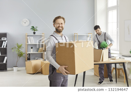 Professional movers carry boxes during office relocation in a bright workspace Professional movers carry boxes during office relocation in a bright workspace 132194647