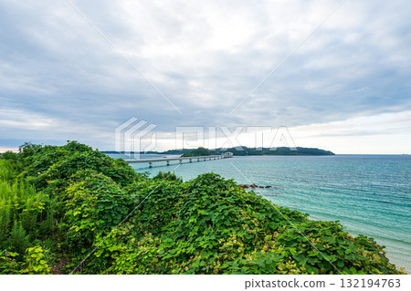 Waves crashing on the beautiful sandy beach of Tsunoshima and the Tsunoshima Bridge Waves crashing on the beautiful sandy beach of Tsunoshima and the Tsunoshima Bridge 132194763