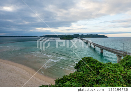 Waves crashing on the beautiful sandy beach of Tsunoshima and the Tsunoshima Bridge 132194786