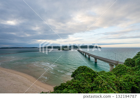Waves crashing on the beautiful sandy beach of Tsunoshima and the Tsunoshima Bridge Waves crashing on the beautiful sandy beach of Tsunoshima and the Tsunoshima Bridge 132194787